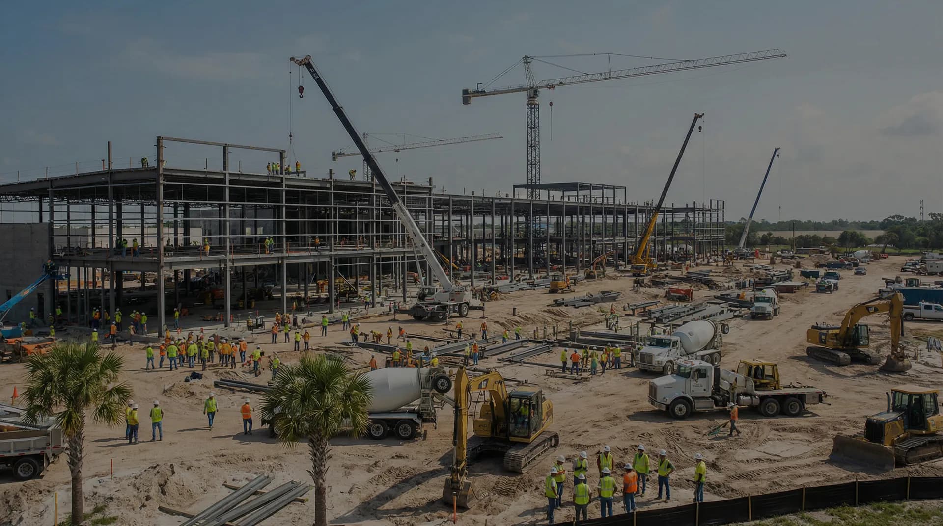 Large contractor project site with heavy equipment and workers